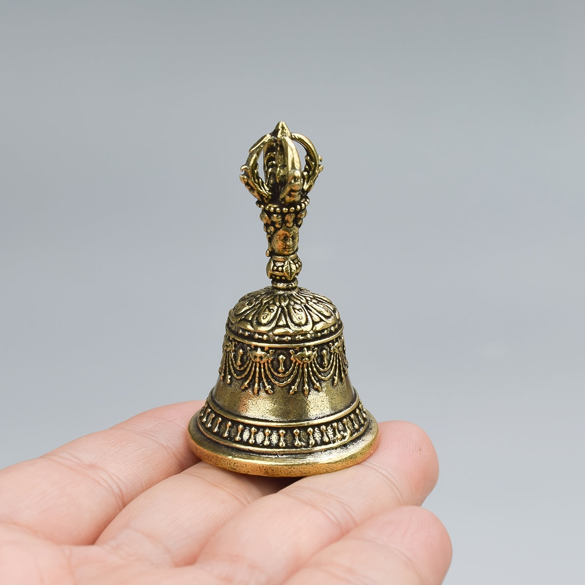 one carved bronze bell hand held shaker clapping handle
